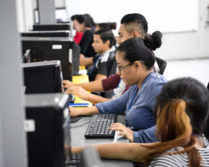 Adult students at desktops learning