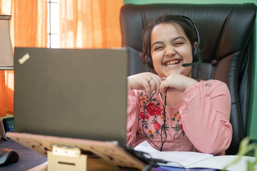 Young Student with donated laptop for schoolwork